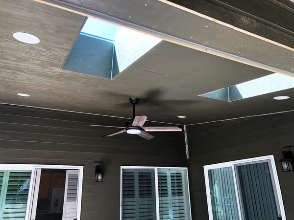 Ceiling fan and recessed can lights in outdoor covered patio
