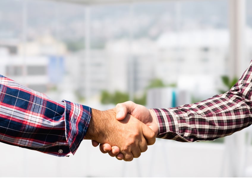 Customer and electrician shaking hands agreeing to scope of work