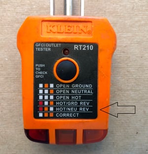 Outlet tester showing that outlet wiring has been reversed, reverse polarity