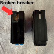 The backside of two tandem breakers. One showing that the rejection clip has been removed and broke the breaker.